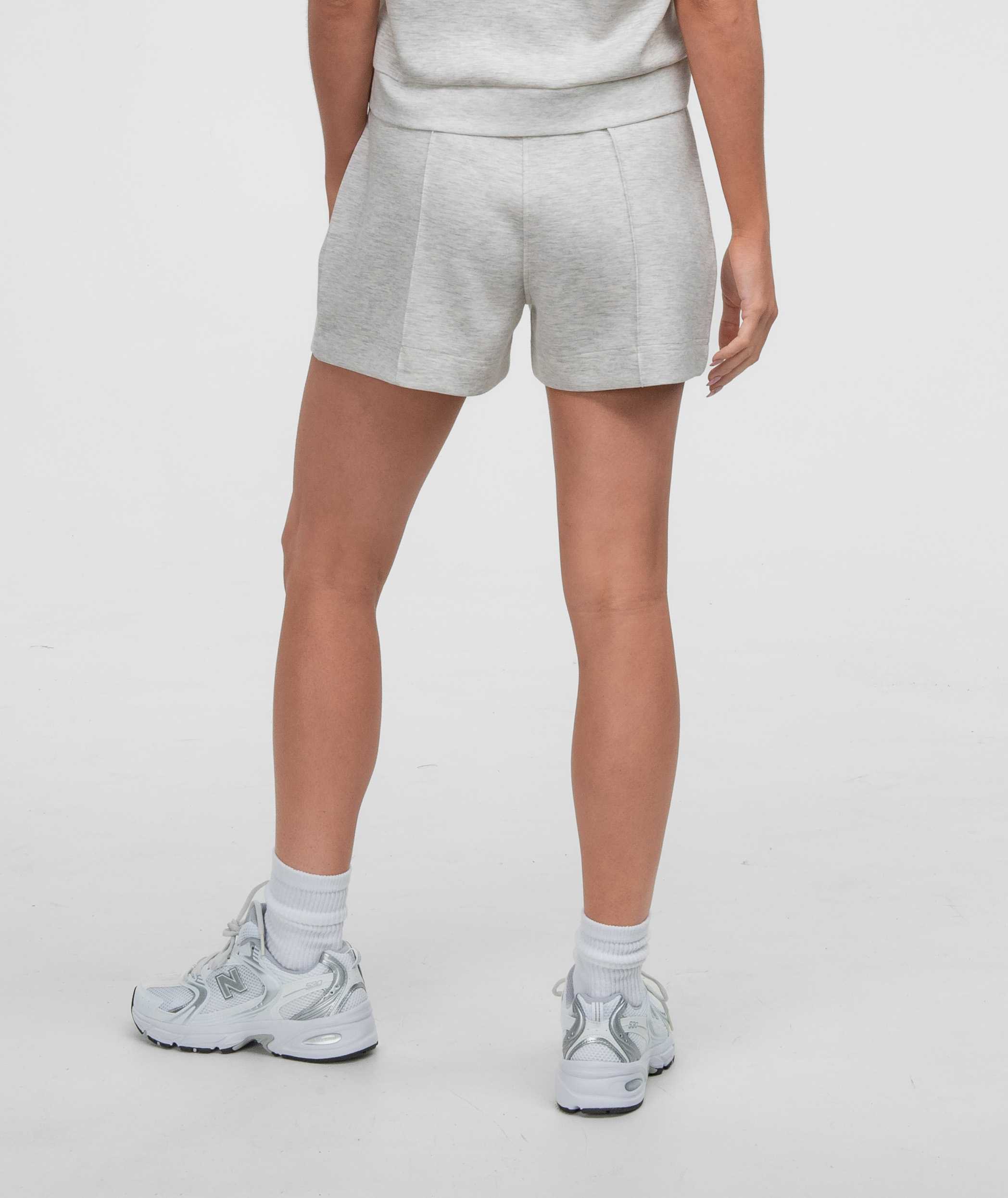 Model wearing AstroKnit Shorts from the back, showcasing a stylish and comfortable casual look.